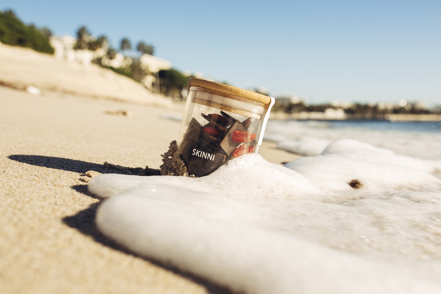 jar-of-skinni-on-the-beach-with-foam